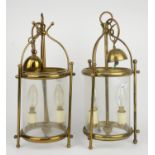 A pair of 20th century gilt brass hall lanterns of cylindrical form, each enclosing a twin light