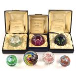 Three Caithness glass paperweights ; 'Morning Dew', 'Flower in the Rain' and 'May Dance',