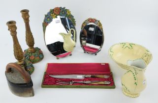 A 1930's strut back oval mirror with polychrome painted floral plaster crest, 31cm high, a similar,