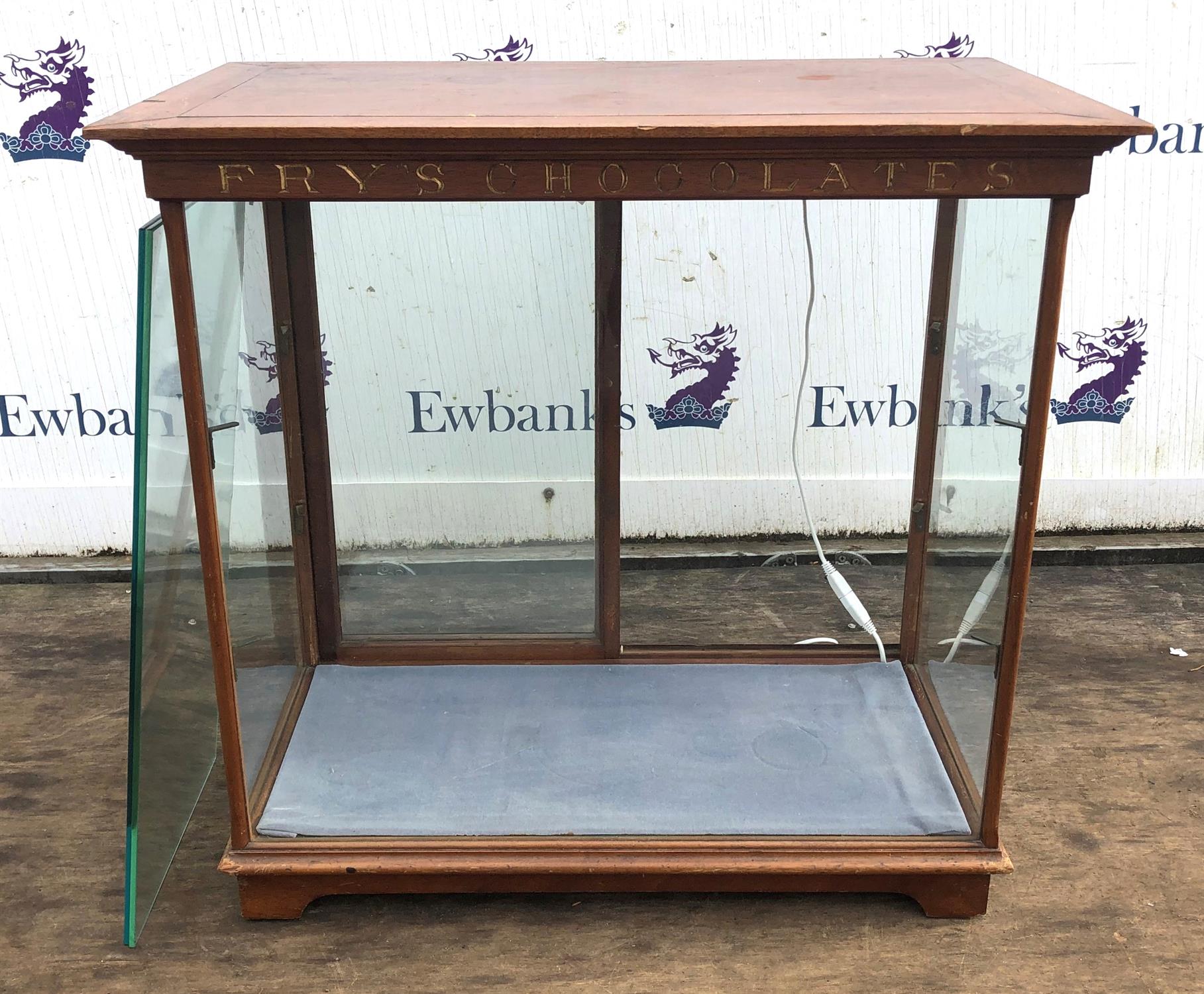 Fry's Chocolate sweet display cabinet, with brass brackets and glass shelves, on bracket feet,