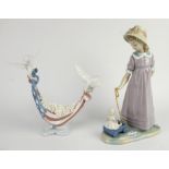 A Llladro porcelain figure depicting a young girl pulling a toy wagon, No 5044 and one further