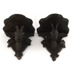 Two similar early 20th century Black Forest wall brackets, each carved with mountain goats beneath