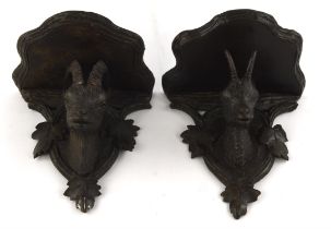 Two similar early 20th century Black Forest wall brackets, each carved with mountain goats beneath