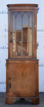 A modern mahogany corner display cupboard with glazed, hinged door, 181cm high