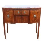 A Regency mahogany bowfront sideboard, ebony strung, the central drawer above a drawer flanked by a