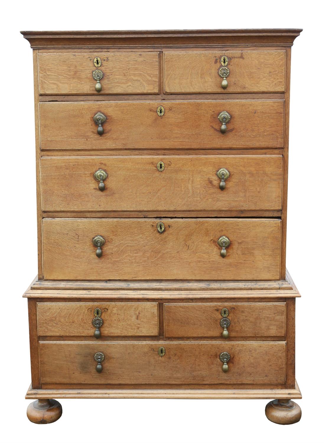 A George II oak chest on chest, sides panelled, on later bun feet, H 132cm, W 102cm, D 58cm