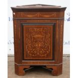 An Edwardian mahogany and inlaid corner cupboard base, inlaid with foliate arabesques,