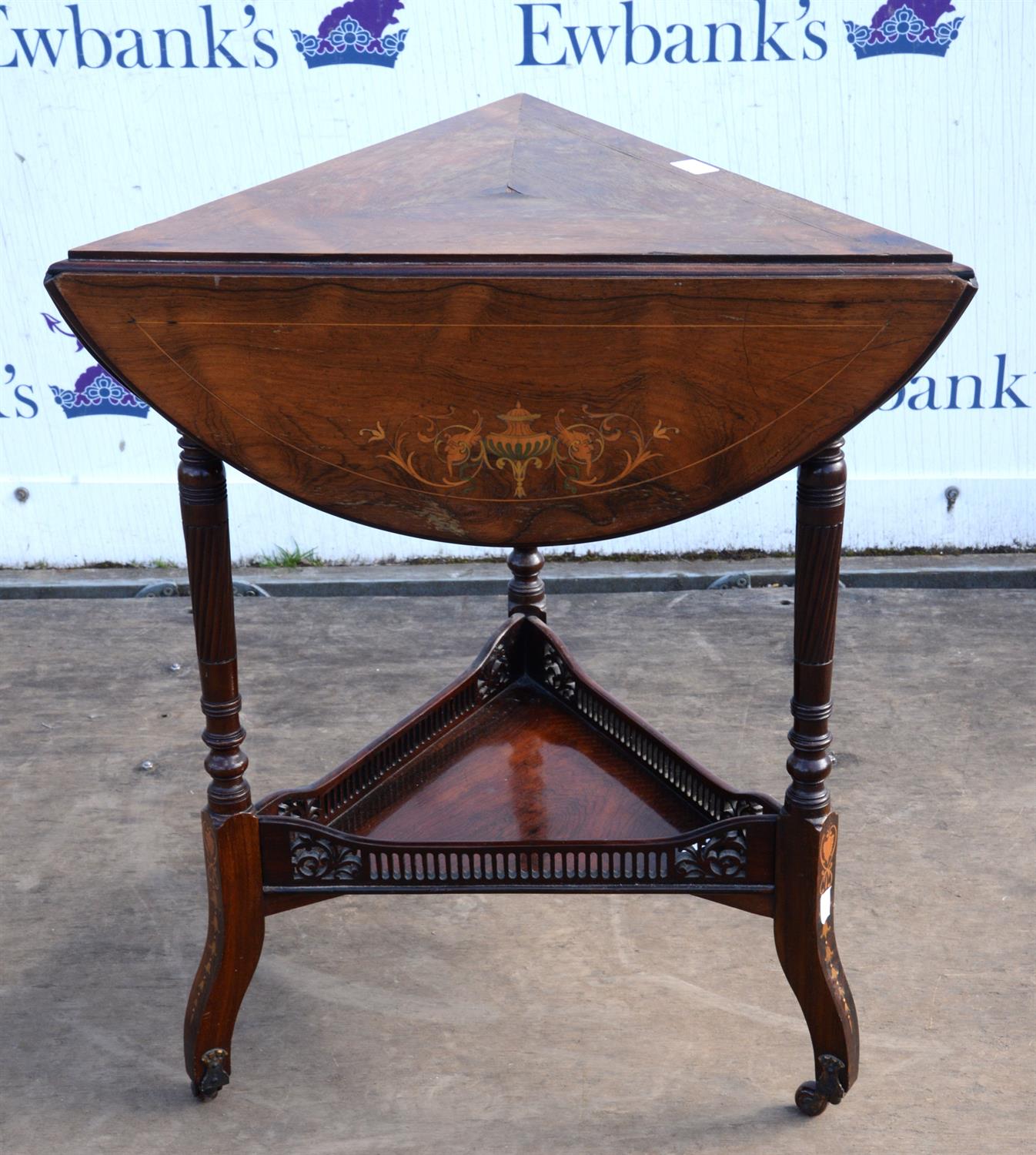 An Edwardian rosewood and inlaid envelope occasional table, each flap inlaid with flowering urns,