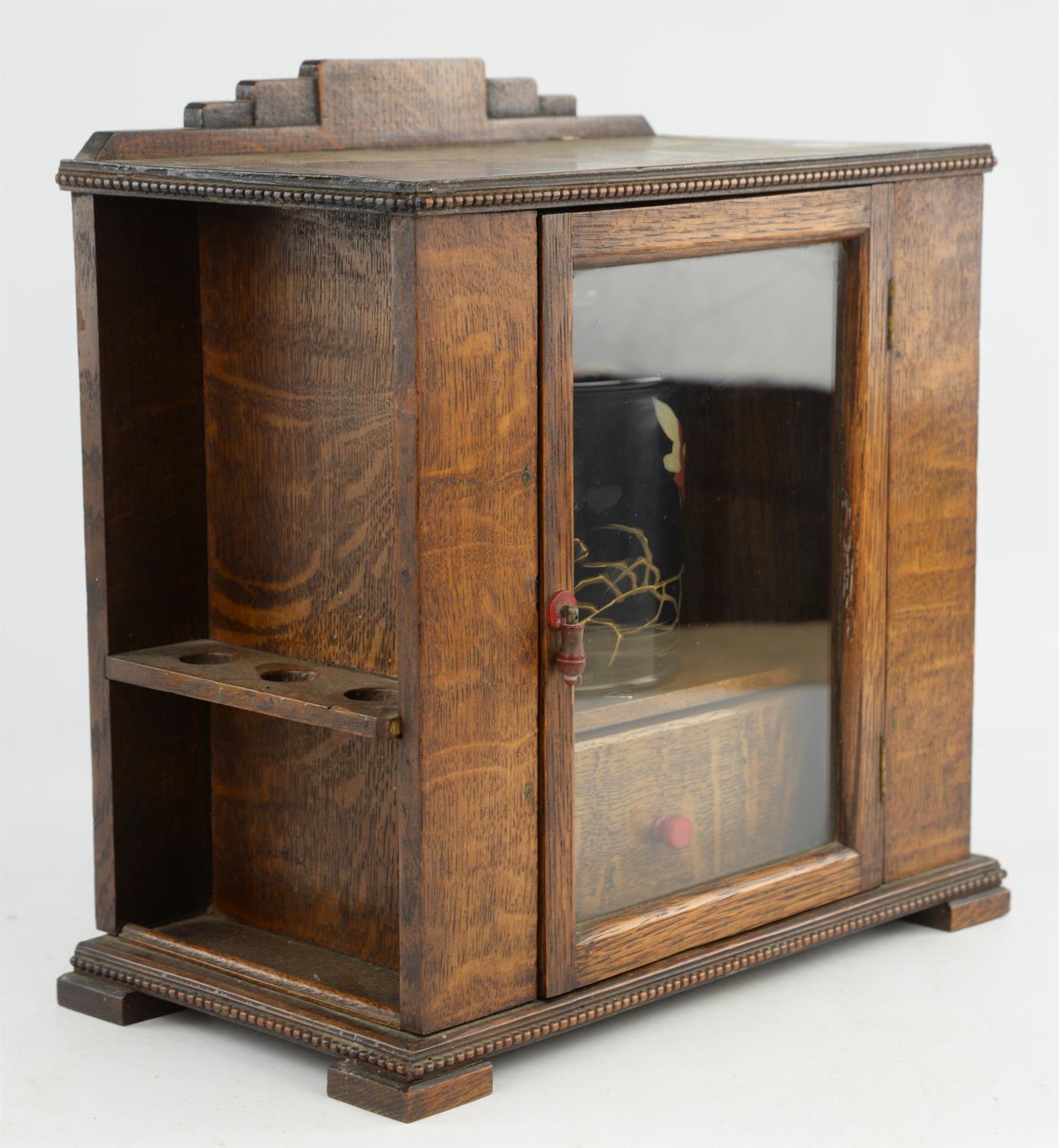 An early 20th century oak smokers cabinet with glazed, hinged door, containing a tobacco box and - Bild 2 aus 4