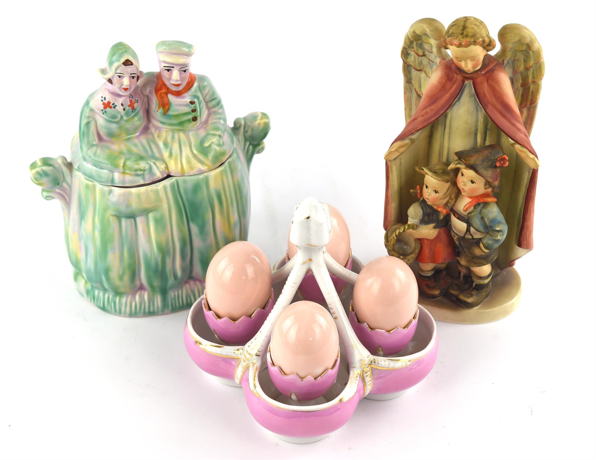 Late 19th century egg server, with four cups and fake eggs, together with a Goebbels figure of an