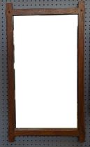 An Arts and Crafts style rectangular oak wall mirror, height 63cm x 35cm and a modern giltwood