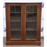 An Edwardian mahogany bookcase, the pair of glazed doors enclosing three adjustable shelves,