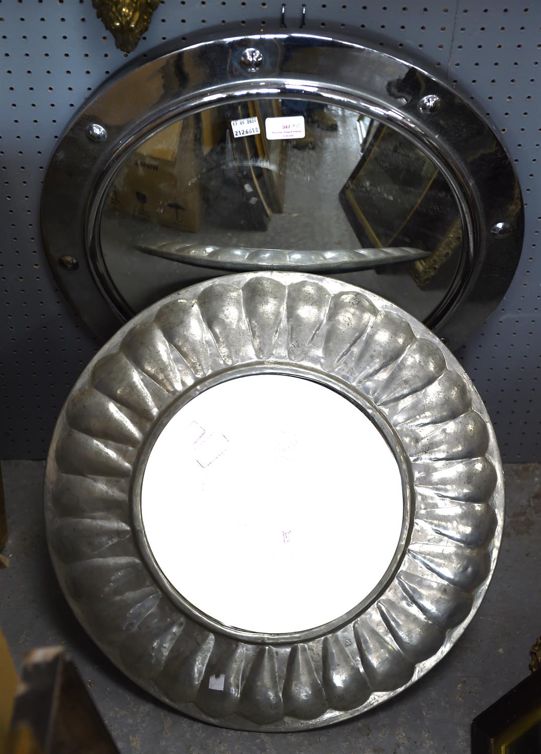 A modern circular chromed wall mirror of 'port hole' form, diameter 52cm and one further circular