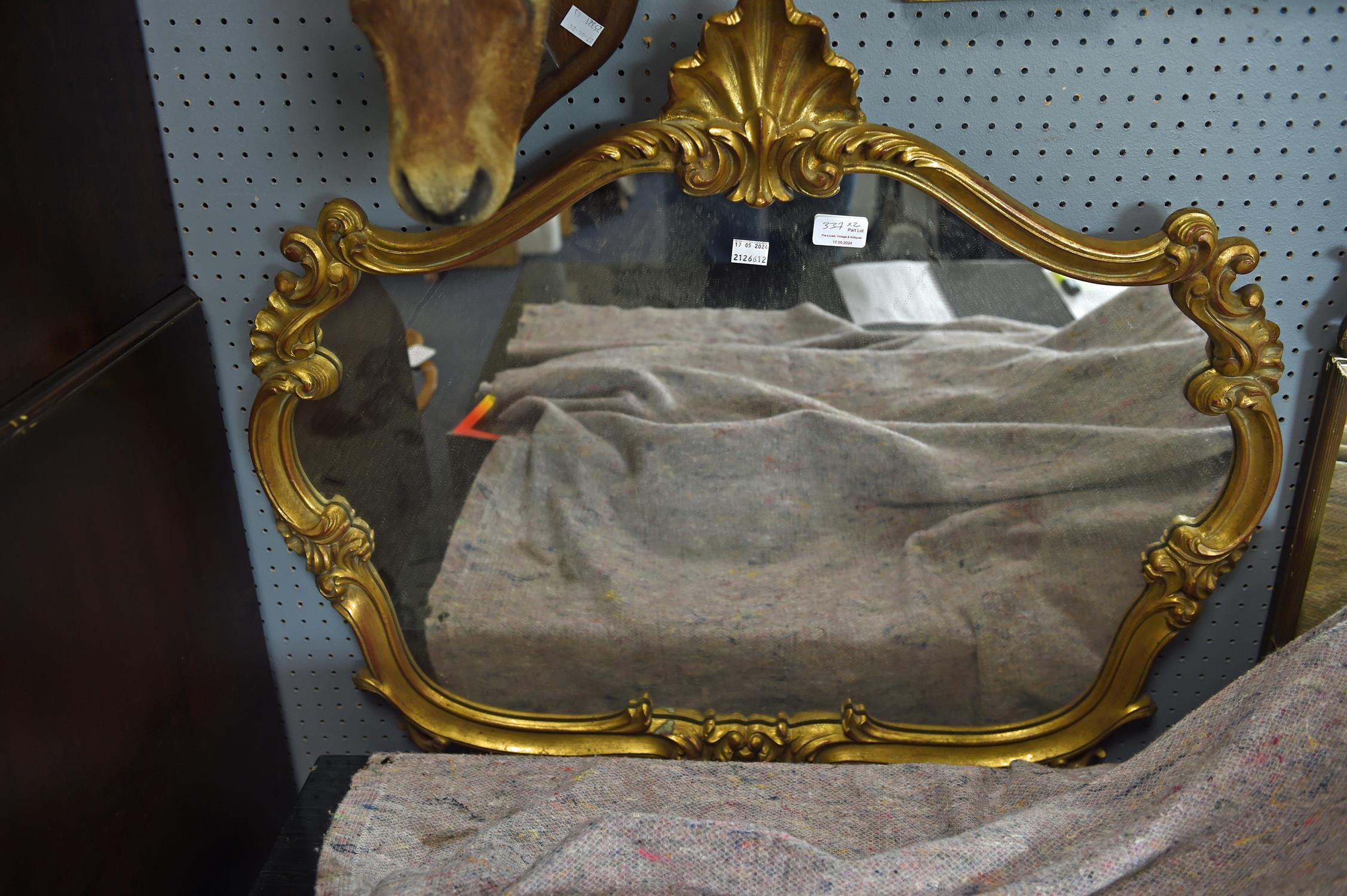 A late 19th century style gilt composite wall mirror of shaped outline, width 81cm,