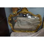 A late 19th century style gilt composite wall mirror of shaped outline, width 81cm,