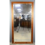 A Victorian style pine mirror, modern, the bevelled plate within a moulded frame with brass inner