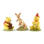 Nineteen Royal Doulton porcelain figures from the 'Winnie the Pooh' collection including ; Pooh