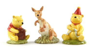 Nineteen Royal Doulton porcelain figures from the 'Winnie the Pooh' collection including ; Pooh