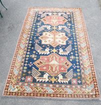 A 20th century Persian, black ground carpet decorated with three lozenges and birds within a wide