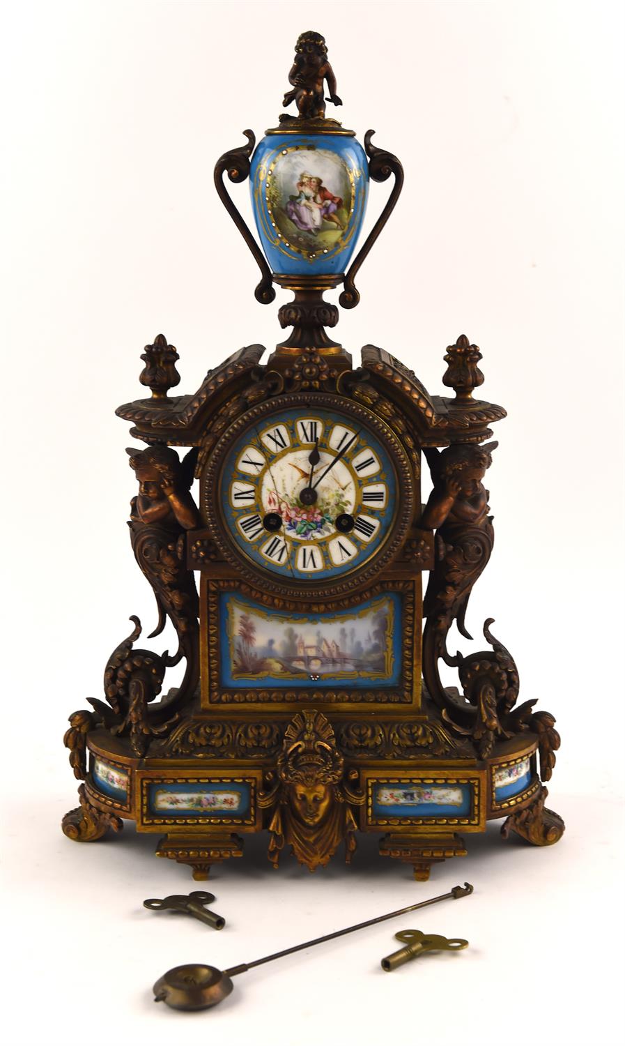 A late 19th century French Ormolu and porcelain mounted mantel clock, with urn finial and painted