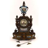 A late 19th century French Ormolu and porcelain mounted mantel clock, with urn finial and painted