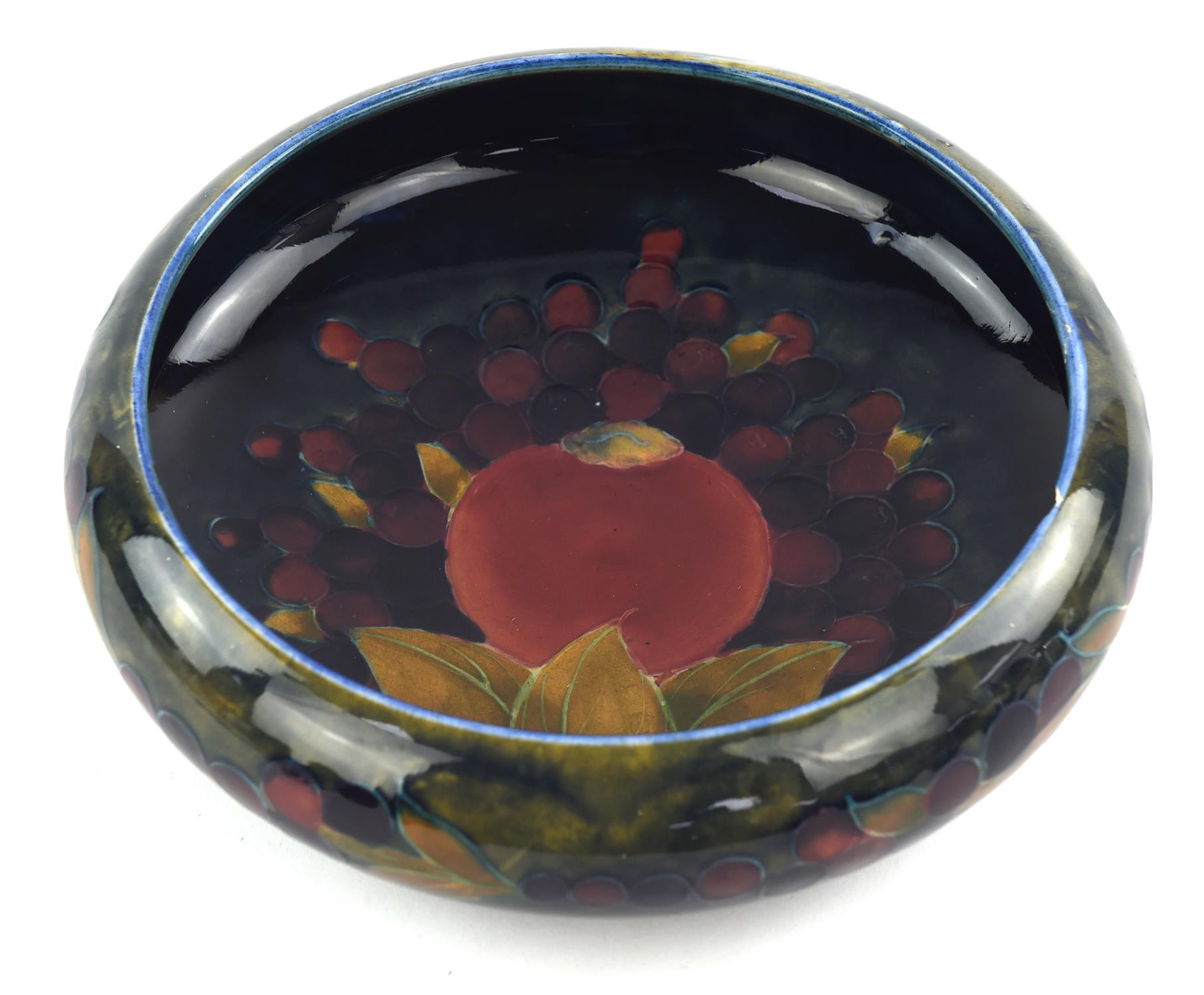 A William Moorcroft (1872-1945) 'Pomegranate' decorated bowl. (chipped) Diameter 24cm