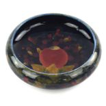 A William Moorcroft (1872-1945) 'Pomegranate' decorated bowl. (chipped) Diameter 24cm