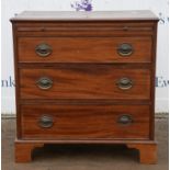 A small George III style mahogany bachelor's chest of drawers, with brushing slide and three long