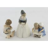 Two Royal Copenhagen figures comprising ; a young Dutch girl, No 1251, and a small girl cuddling a