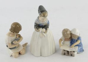 Two Royal Copenhagen figures comprising ; a young Dutch girl, No 1251, and a small girl cuddling a