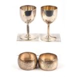 Pair of goblet form silver egg cups and a pair of 830 grade silver napkin rings