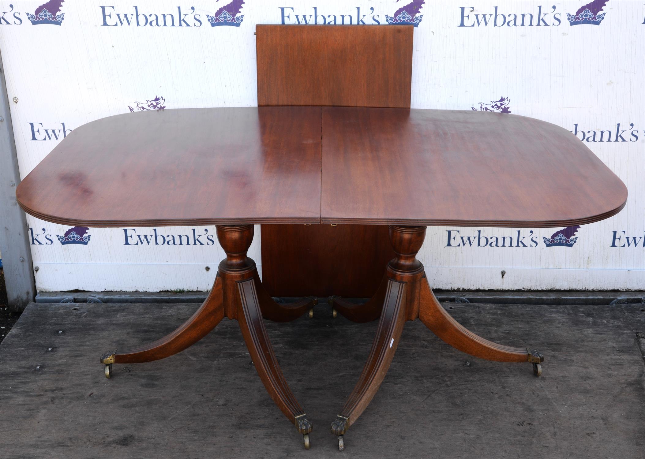A Regency style mahogany dining table, the top George III, the rounded ends on turned bases with