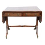 A Regency mahogany sofa table, satinwood banded and ebony strung, the top with canted corners,