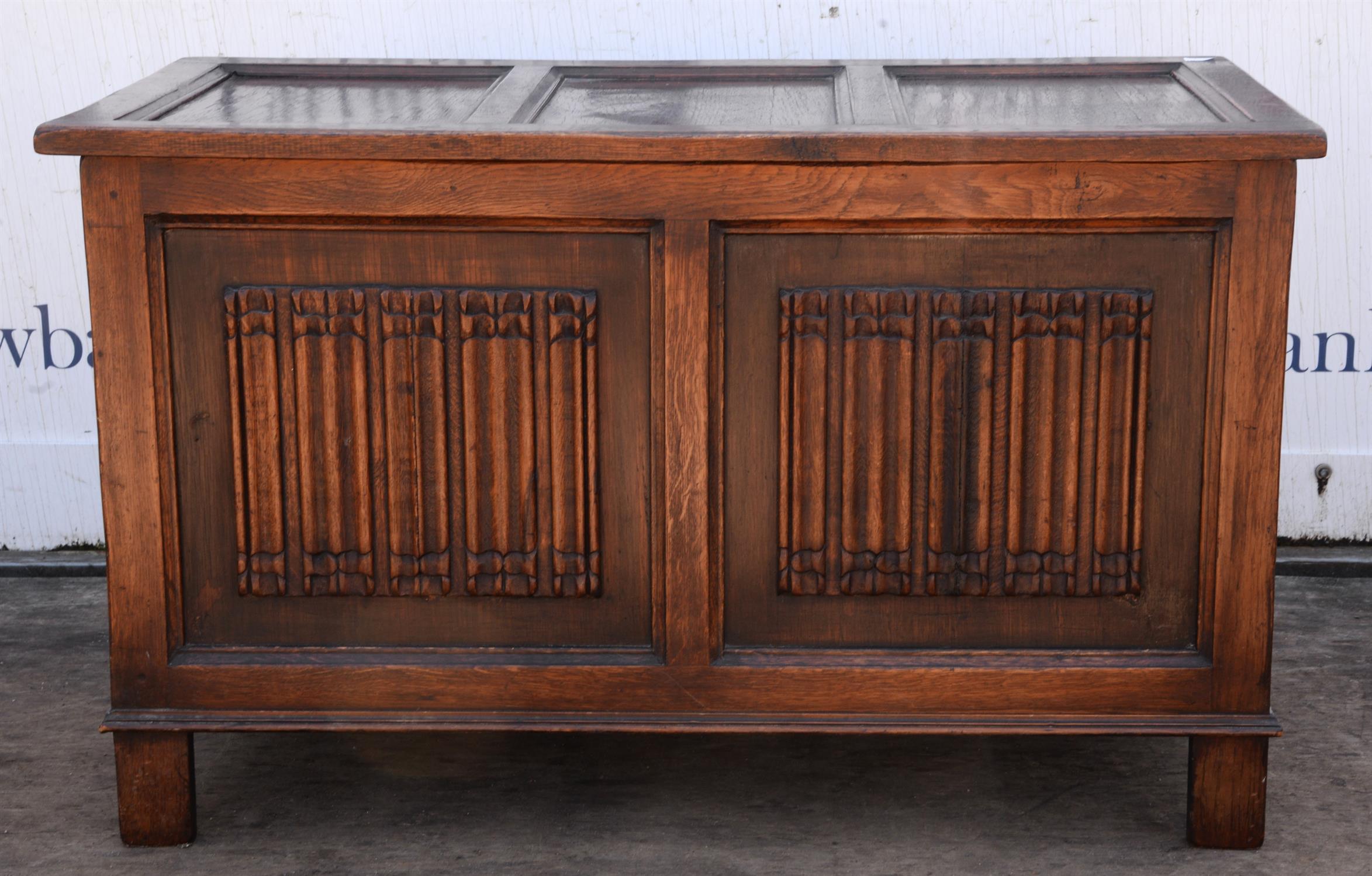 An Elizabethan style oak coffer, 1920s/30s, the front with a pair of linen fold panels, H 56cm,
