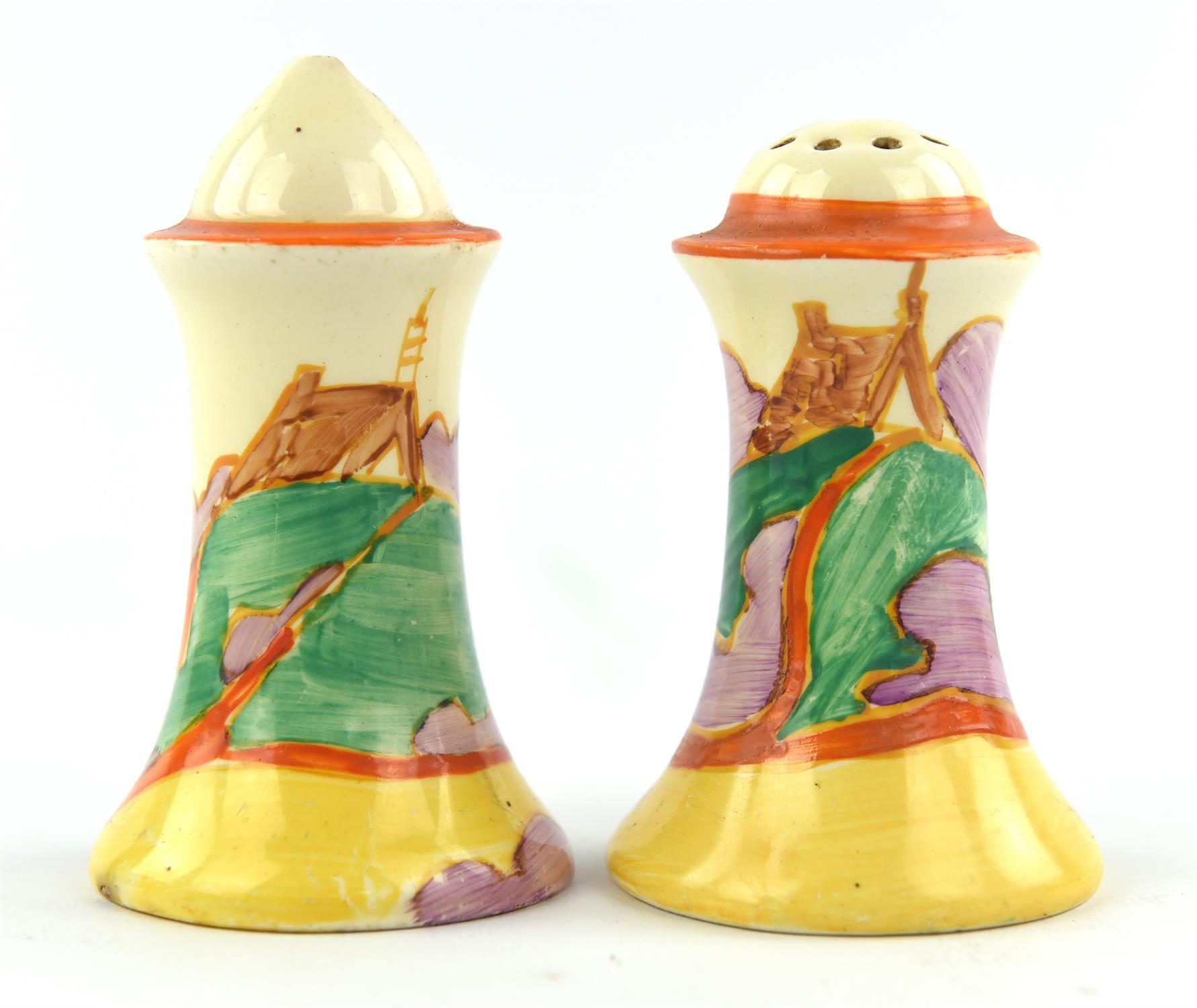 A pair of Clarice Cliff salt and pepper shakers, C.1930, decorated in the 'Orange Roof' pattern.