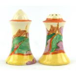 A pair of Clarice Cliff salt and pepper shakers, C.1930, decorated in the 'Orange Roof' pattern.