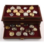 Two wooden display cases containing 81 quartz pocket watches, in base metal. (81)