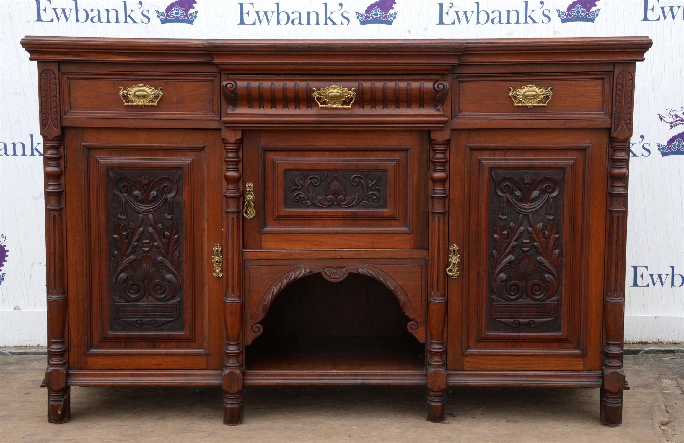 A late Victorian walnut sideboard, of breakfront form, doors scroll and anthemion carved,