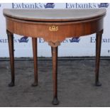 A George II mahogany demi lune form tea table, later crossbanded, with foldover top and tapered