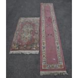 A 20th century Chinese runner with floral borders on a peach and pink ground 335 x 76cms together