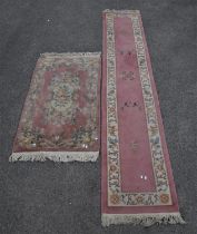 A 20th century Chinese runner with floral borders on a peach and pink ground 335 x 76cms together