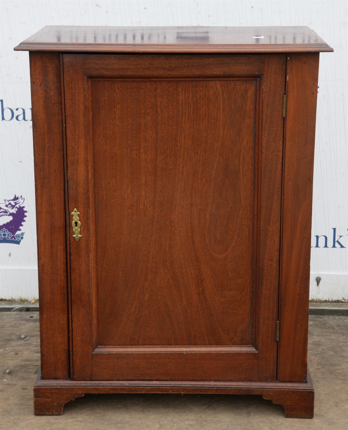 An early Victorian mahogany cabinet, some adaptations, the panel door enclosing three pine shelves,