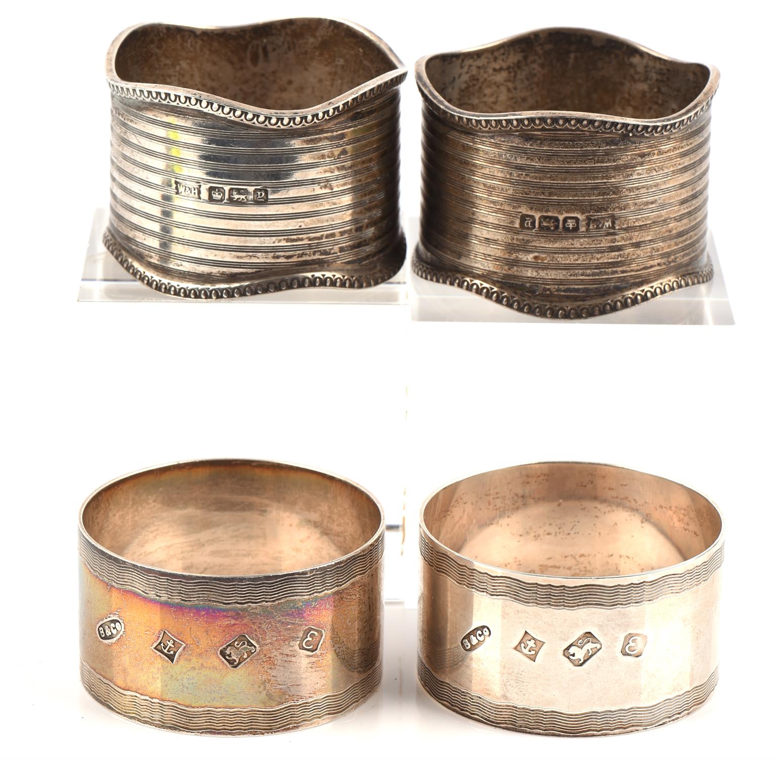 Two pairs of silver napkin rings, 120gms