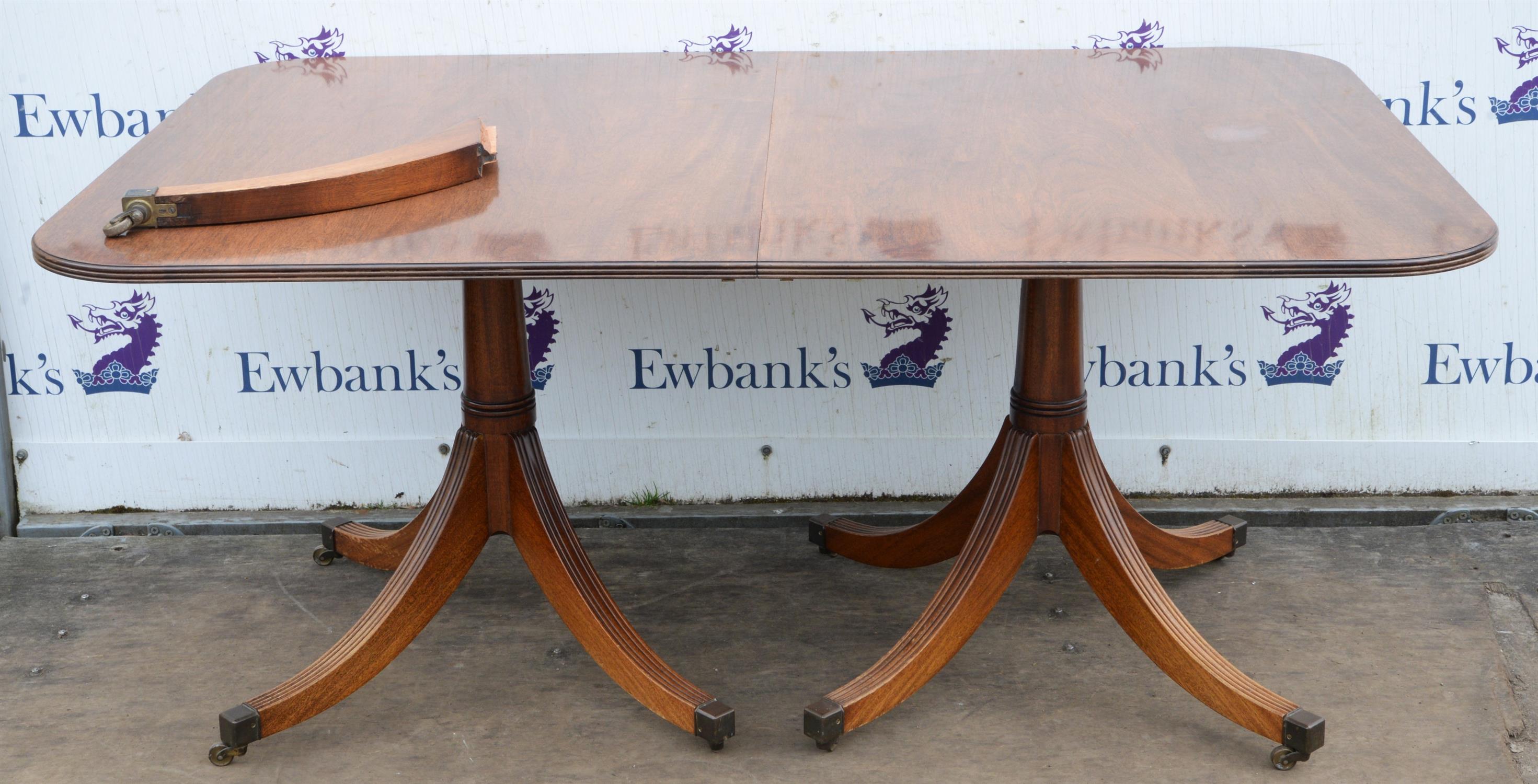 A Regency mahogany twin pillar dining table, the column supports with quadruple sabre legs and