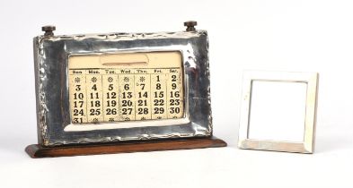 Large silver framed perpetual calendar and a silver photo frame