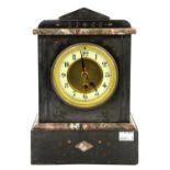 A Victorian black slate cased mantel clock with foliate carved decoration and a later Quartz