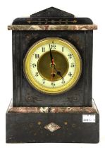 A Victorian black slate cased mantel clock with foliate carved decoration and a later Quartz