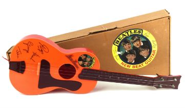 The Beatles New Beat orange toy Guitar in box. These guitars were made in England by Selco in 1964.