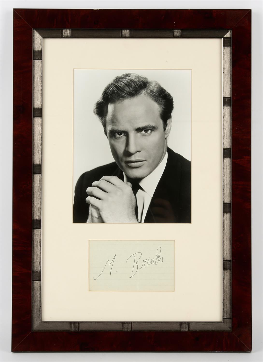 Marlon Brando Framed and Glazed Autograph, presented beneath a b/w photo of the actor c’ early