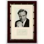 Marlon Brando Framed and Glazed Autograph, presented beneath a b/w photo of the actor c’ early